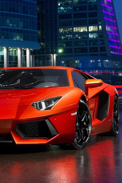Bright Orange Lamborghini Aventador at Night Cityscape