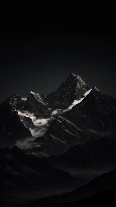 Dark Mountain Peaks with Wispy Clouds and Snow