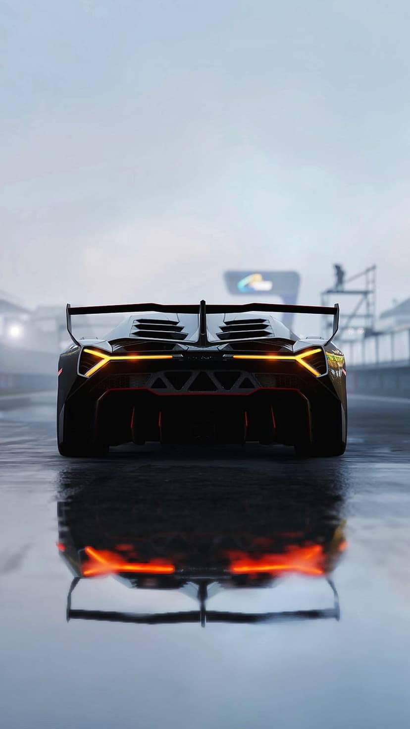 Lamborghini Centenario rear view with orange lights on a wet racing track at night under a dark overcast sky.