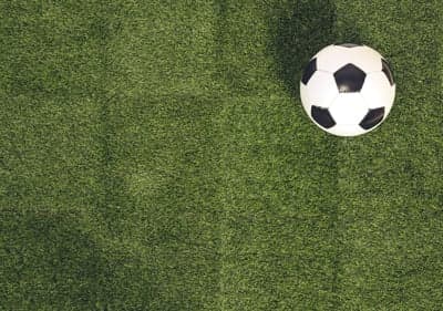 Soccer ball on artificial turf, top-down view