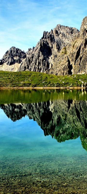 Serene Mountain Lake Reflection Under Blue Sky