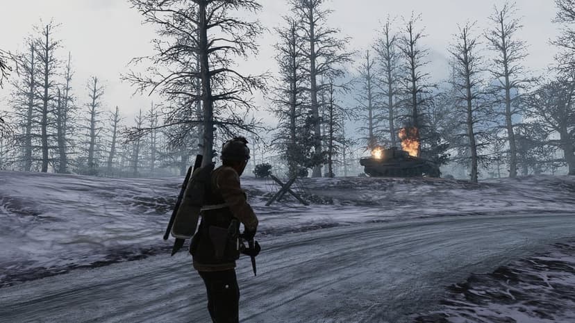Soldier looking at a burning Tiger tank on a snowy road through a misty winter forest in a military game.