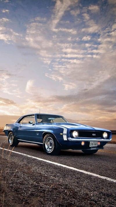 Classic Blue Camaro SS on Rural Road at Sunset
