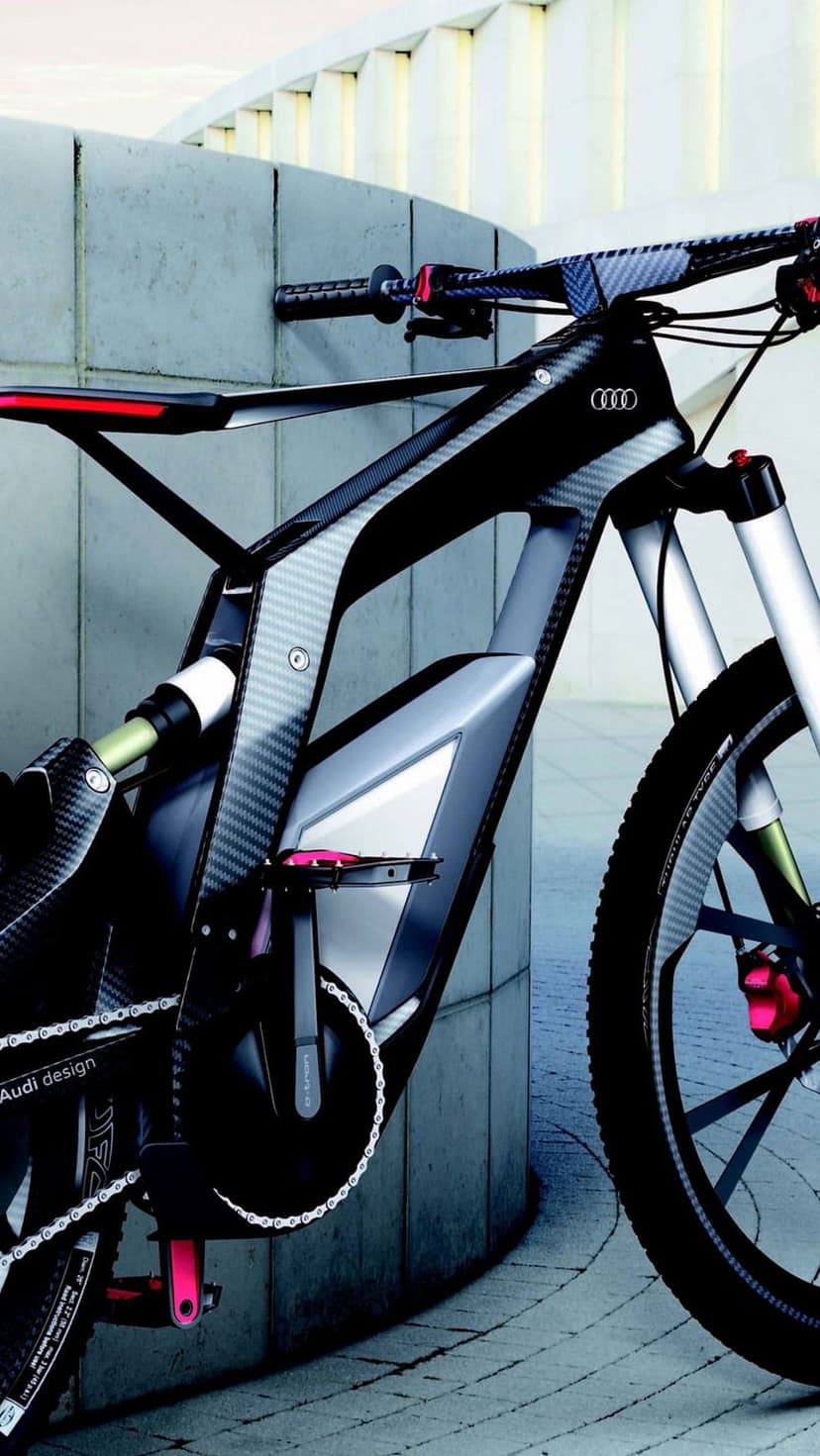 Audi electric bicycle with a black carbon fiber frame and integrated battery shown in a detailed close-up view.