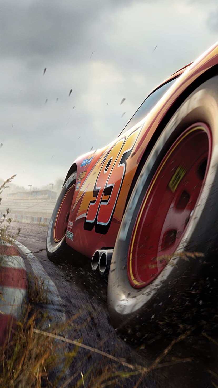 Lightning McQueen drifts on a muddy track with dust clouds and red paint details visible in a close-up shot.