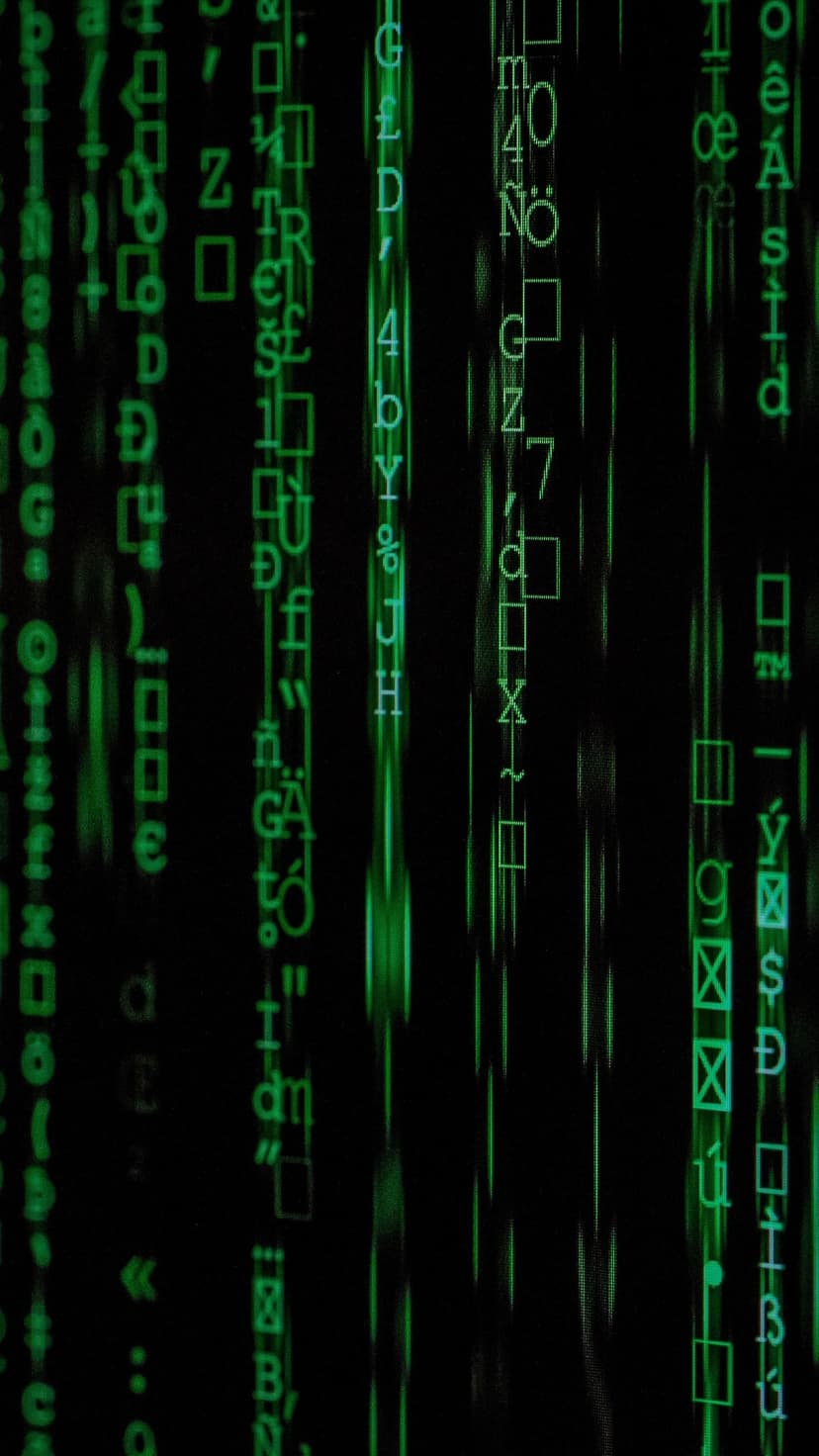 Green digital characters and symbols fall vertically against a black background in a cascading code pattern.