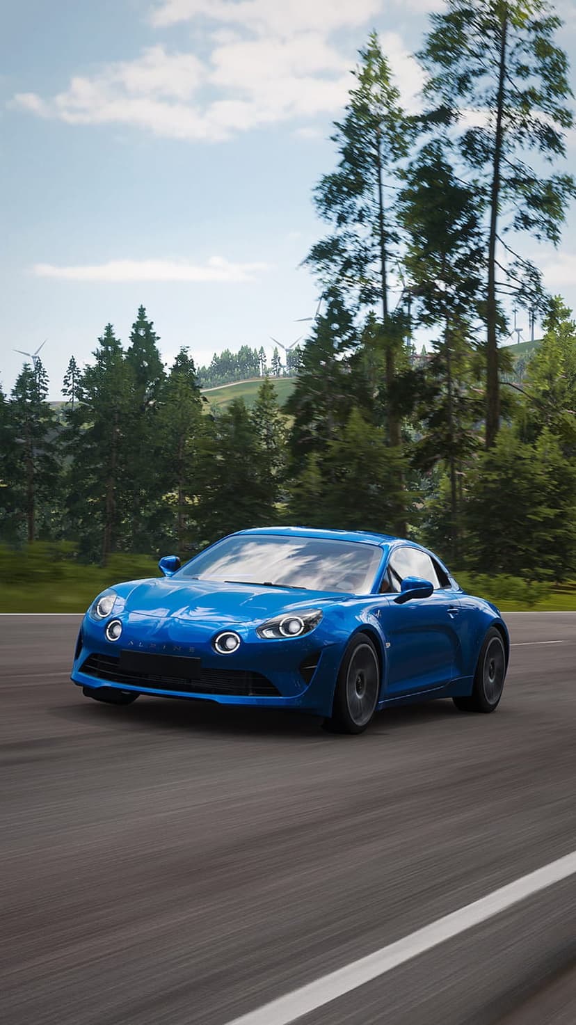 Blue Alpine A110 sports car drives on a paved road through green hills with wind turbines under a clear blue sky.