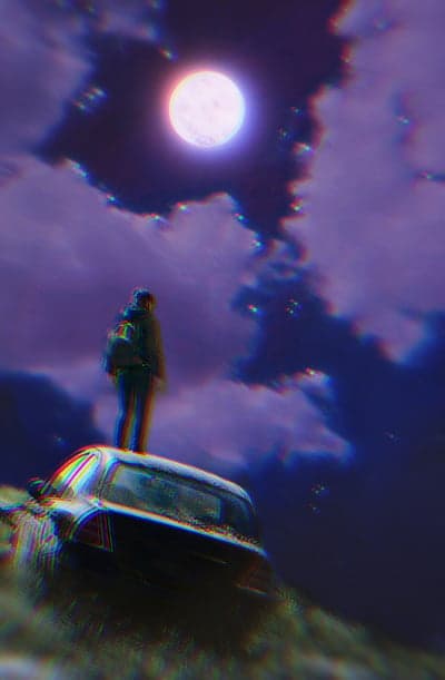 Person on Car Under Full Moon at Night