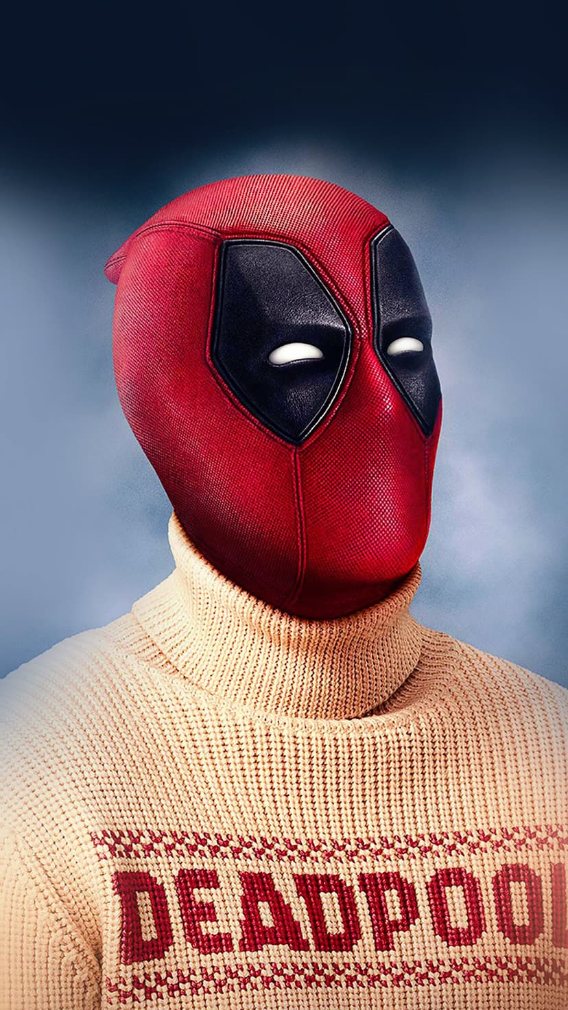 Deadpool wearing a cream turtleneck sweater with festive patterns and his name across the chest in soft light.
