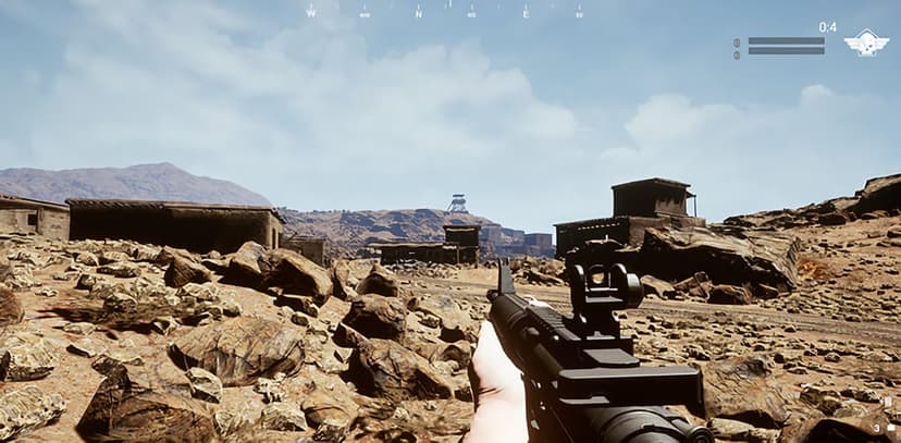 First-person view of a rifle aimed across a rocky desert outpost with stone buildings under a bright sky.
