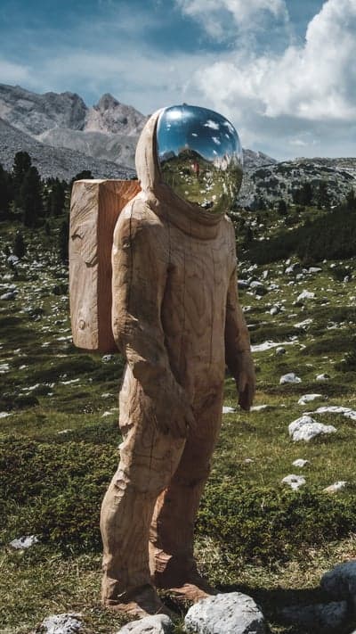 Cosmic Wanderer - A Wooden Astronaut in the Mountains