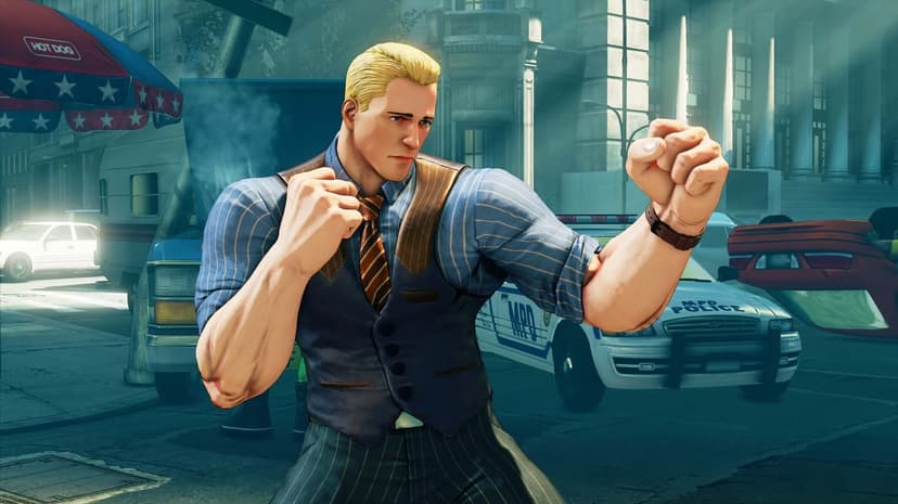 Blonde man in a vest and tie posing with clenched fists on a city street near a police car and hot dog stand.
