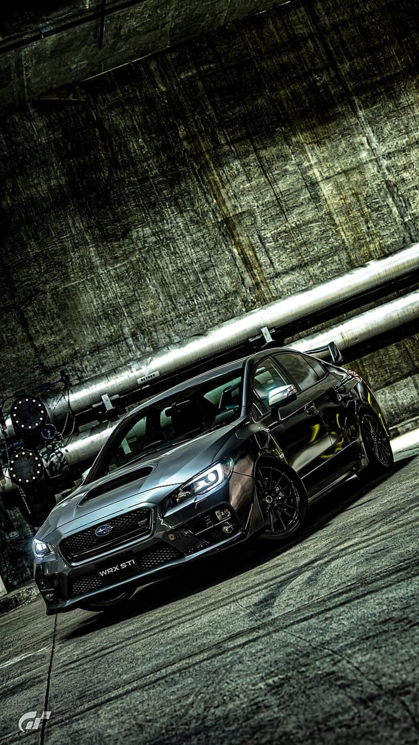 Subaru WRX STI parked in a dark industrial garage with concrete walls and metallic pipes in the background.