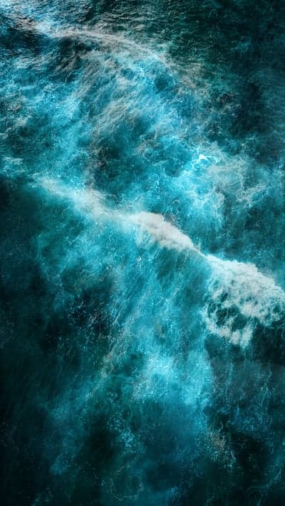 Dramatic Turquoise Ocean Waves Crashing from Above