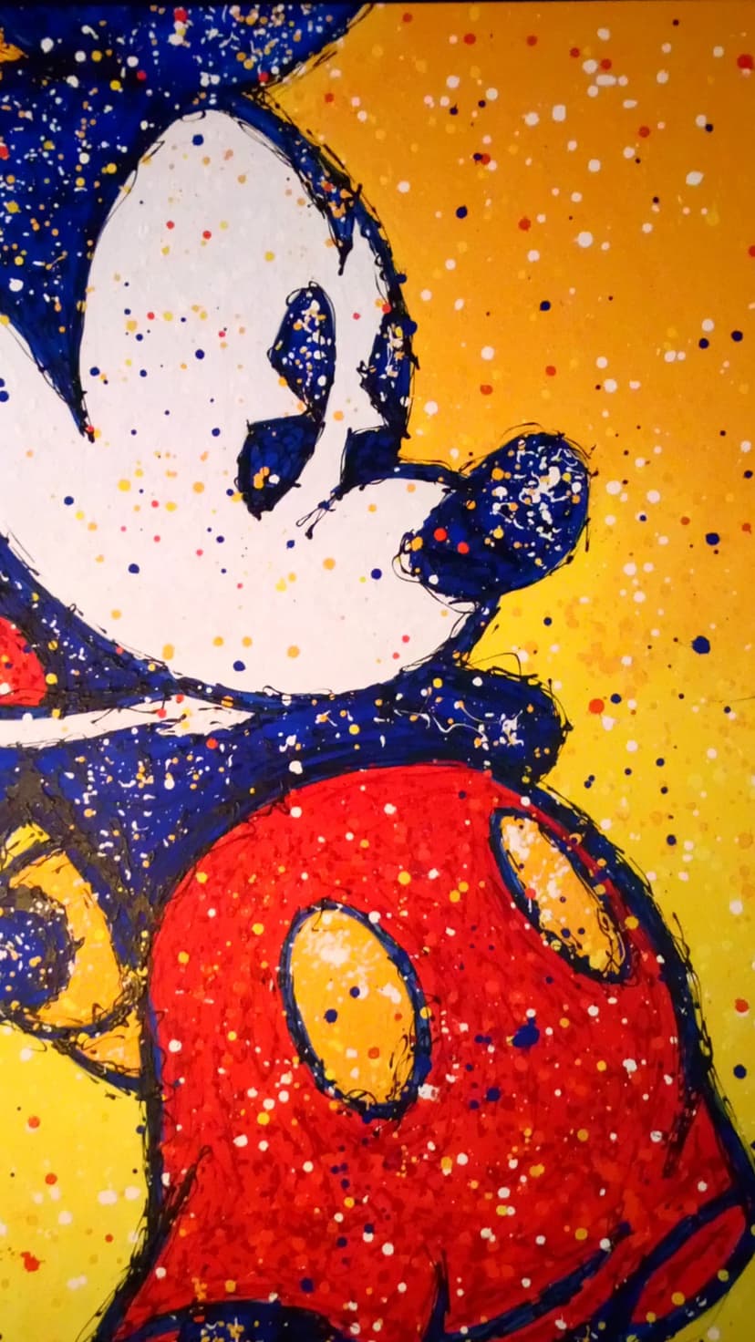 Mickey Mouse face with blue paint splatters and red shorts against a bright yellow background in a pop art style.