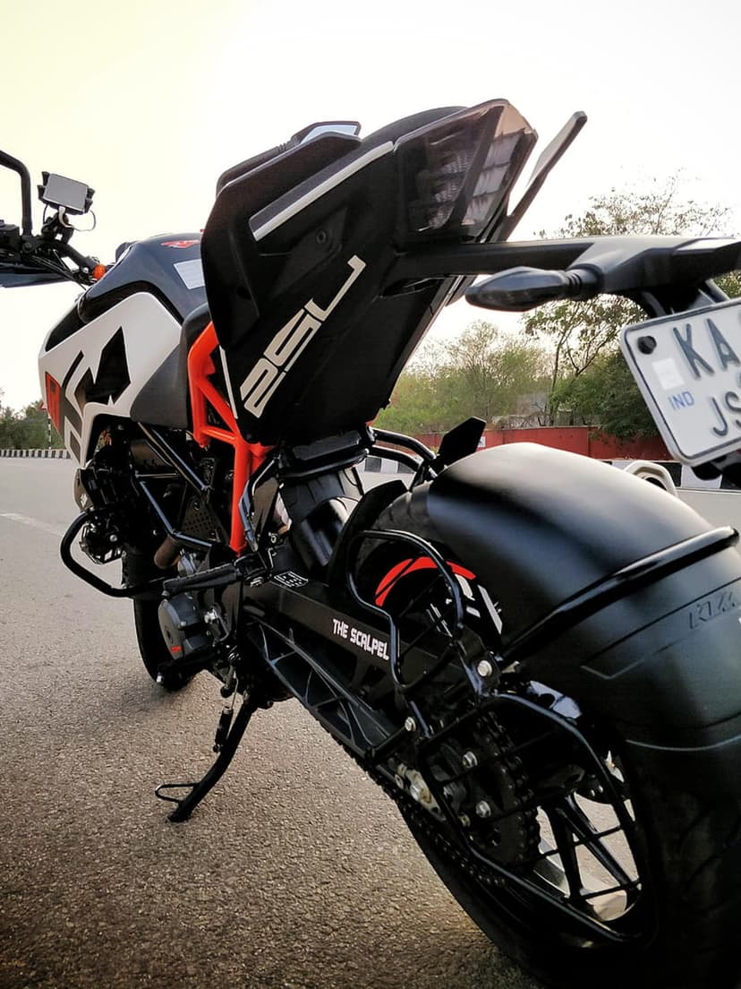 KTM Duke motorcycle rear fender with red LED taillight, license plate, and tail tidy branding in close-up.