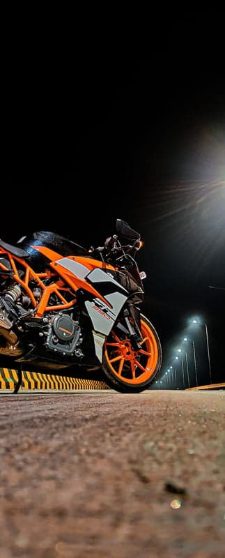 Orange KTM Sportbike Glowing Under Night Streetlights
