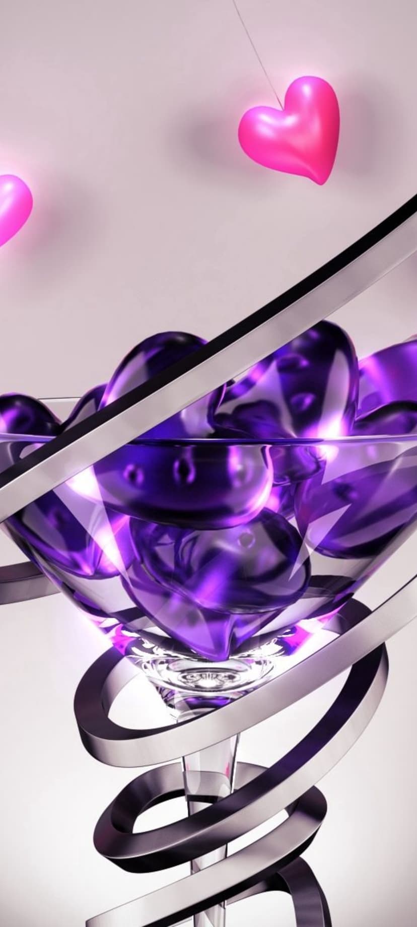 Purple heart gems fill a martini glass wrapped in silver ribbon with pink balloons floating in the background.