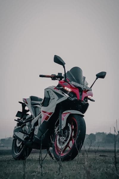 Red and white sport motorcycle parked in field