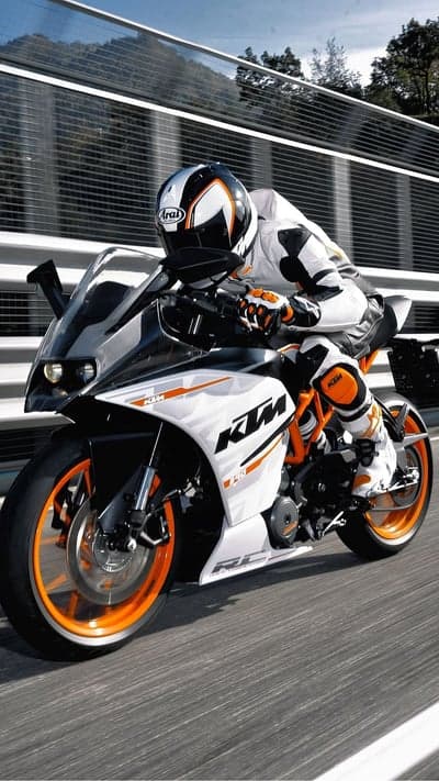 KTM Motorcycle Rider in Full Racing Gear Speeds Down Track