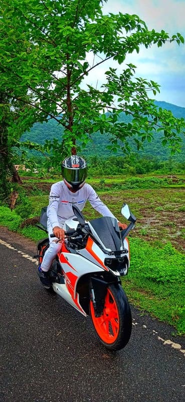 Orange Sportbike Rider Green Mountain Road Phone Wallpaper