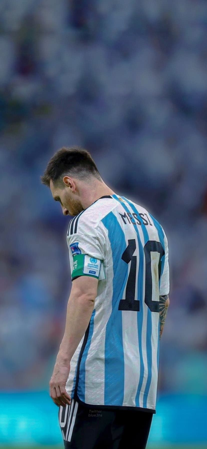 Lionel Messi from behind in a striped Argentina jersey with number ten and a World Cup patch on his sleeve.