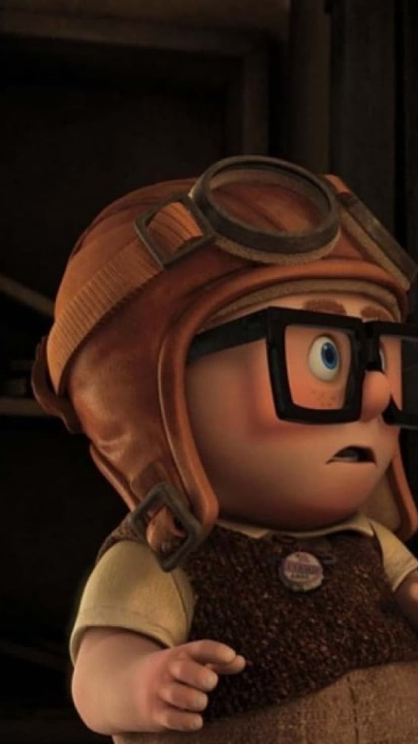 Russell from Up wears a leather aviator cap and thick glasses with a wide-eyed surprised facial expression.