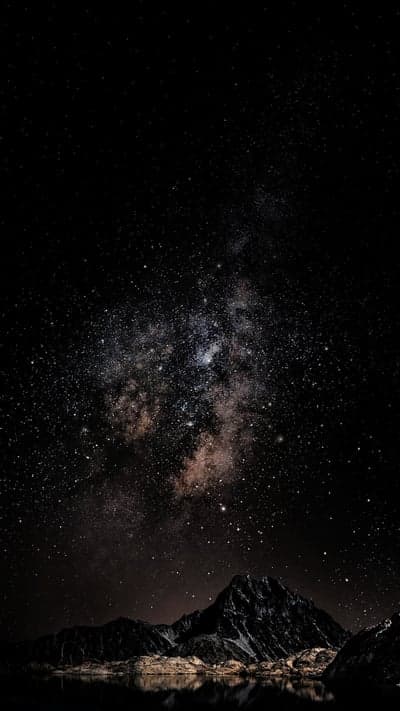 Cosmic Night Sky Over Reflective Mountain Lake Wallpaper