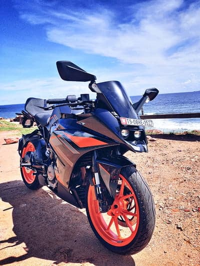 KTM Motorcycle Parked by the Ocean on a Sunny Day