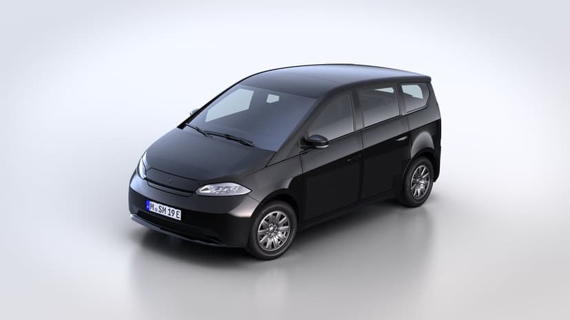 Black Sono Sion solar electric car parked in a bright white studio from a three-quarter front perspective.