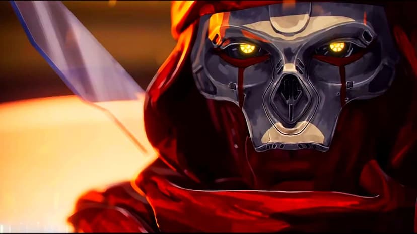 Close up of a mechanical skull mask with glowing yellow eyes and red hood under orange light.