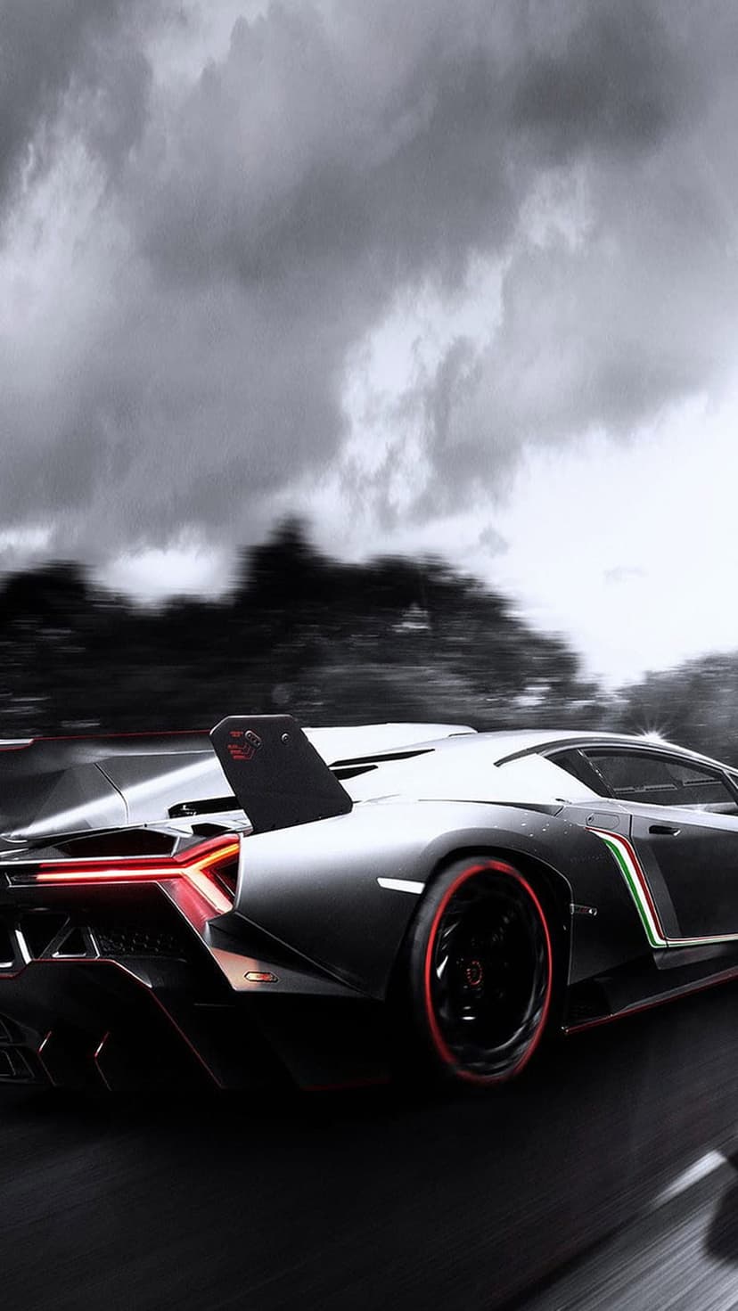 Lamborghini Veneno rear view with red accents and a large wing on a dark wet road under a stormy grey sky.