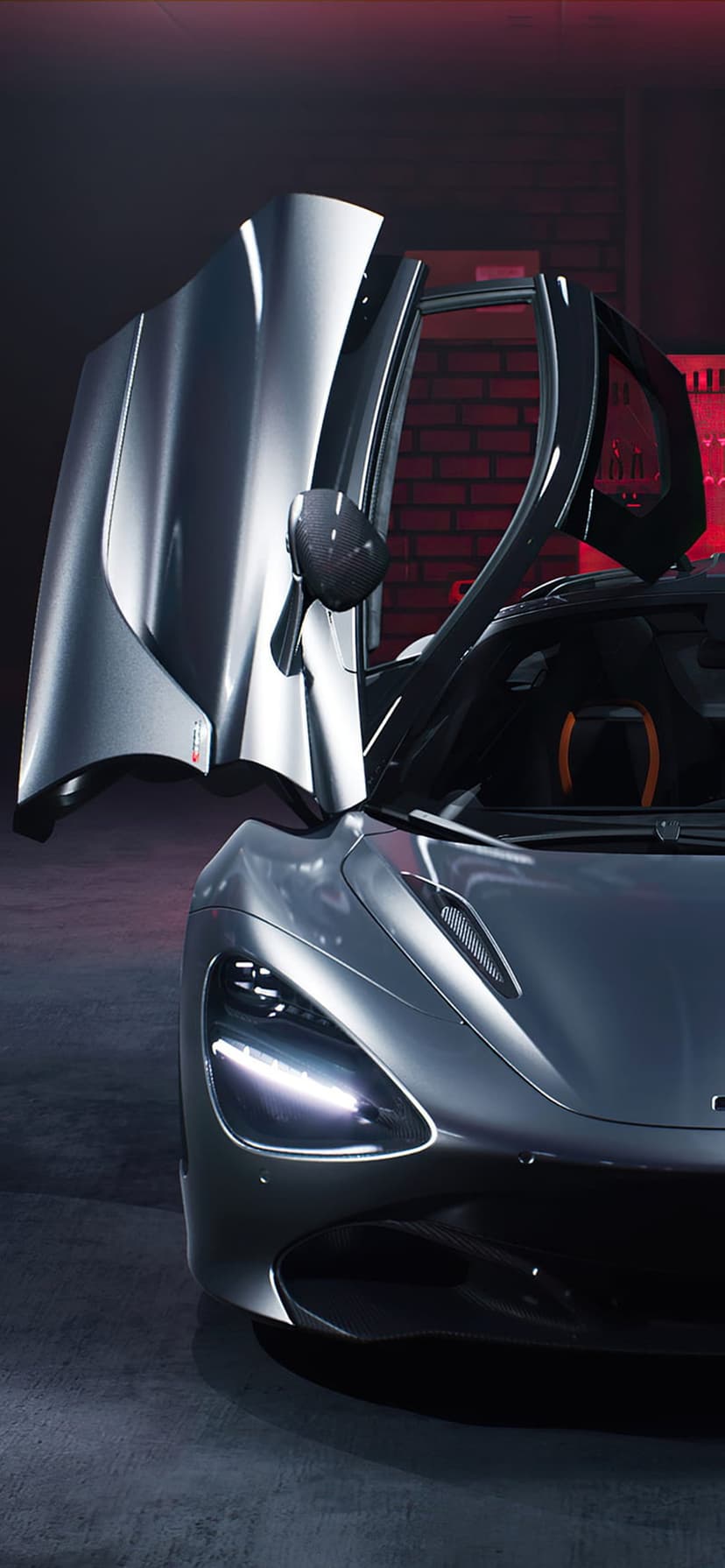 McLaren 720S supercar with gray paint and open dihedral doors parked inside a garage with red brick walls.
