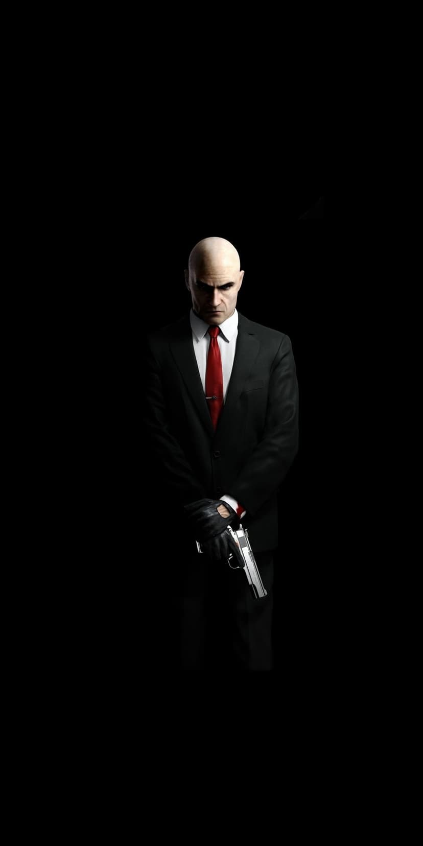 Agent 47 wearing a black suit and red tie, holding a silver handgun against a deep black minimalist background.