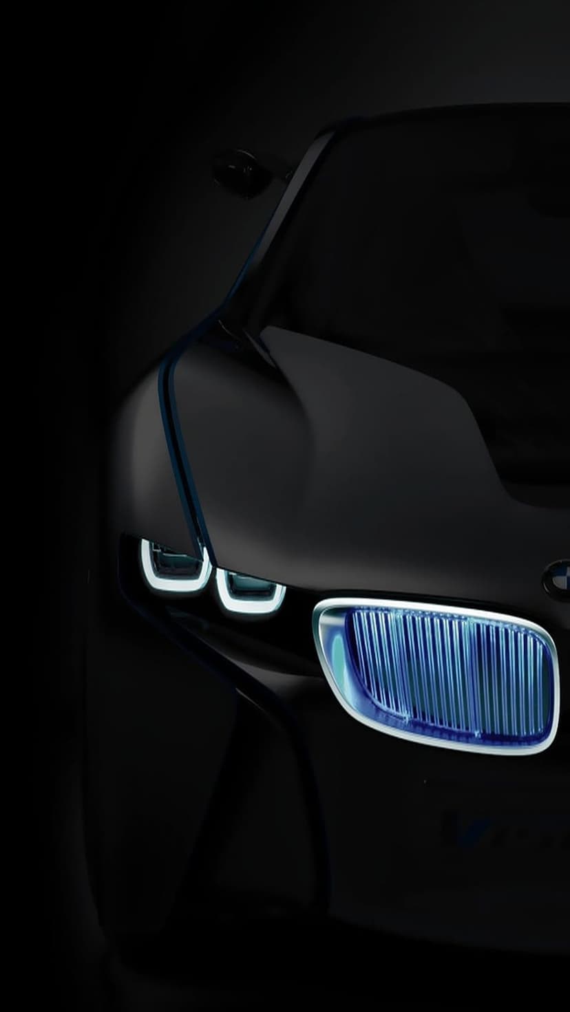 BMW i8 front grille and U-shaped LED headlights glowing with bright blue light against a dark background.