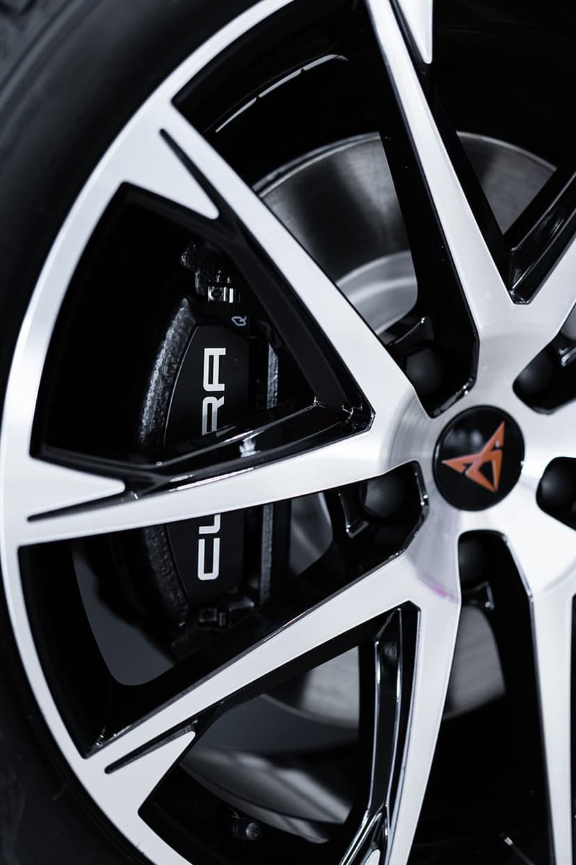 Cupra brake caliper and alloy wheel spokes with a copper center logo in a close-up automotive photography shot.