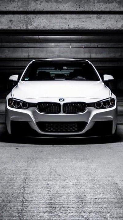 Minimalist White BMW Sedan Concrete Garage Phone Wallpaper