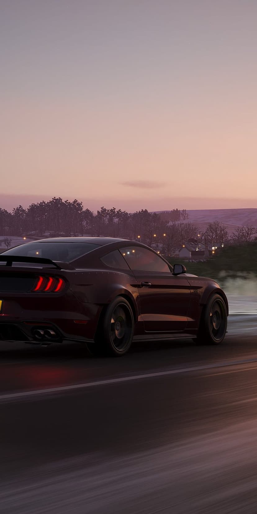 Scarlet Mustang muscle car driving down a road at dusk with illuminated taillights and a purple twilight sky.