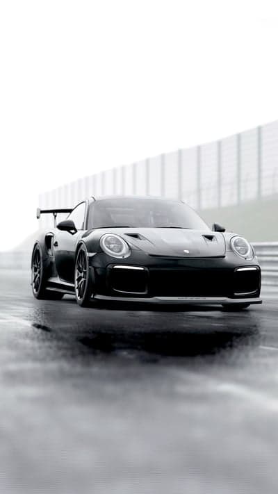 Black Porsche GT2 RS on a Wet Race Track