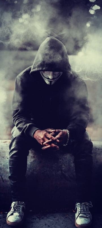 Anonymous figure in smoke with mask and hoodie