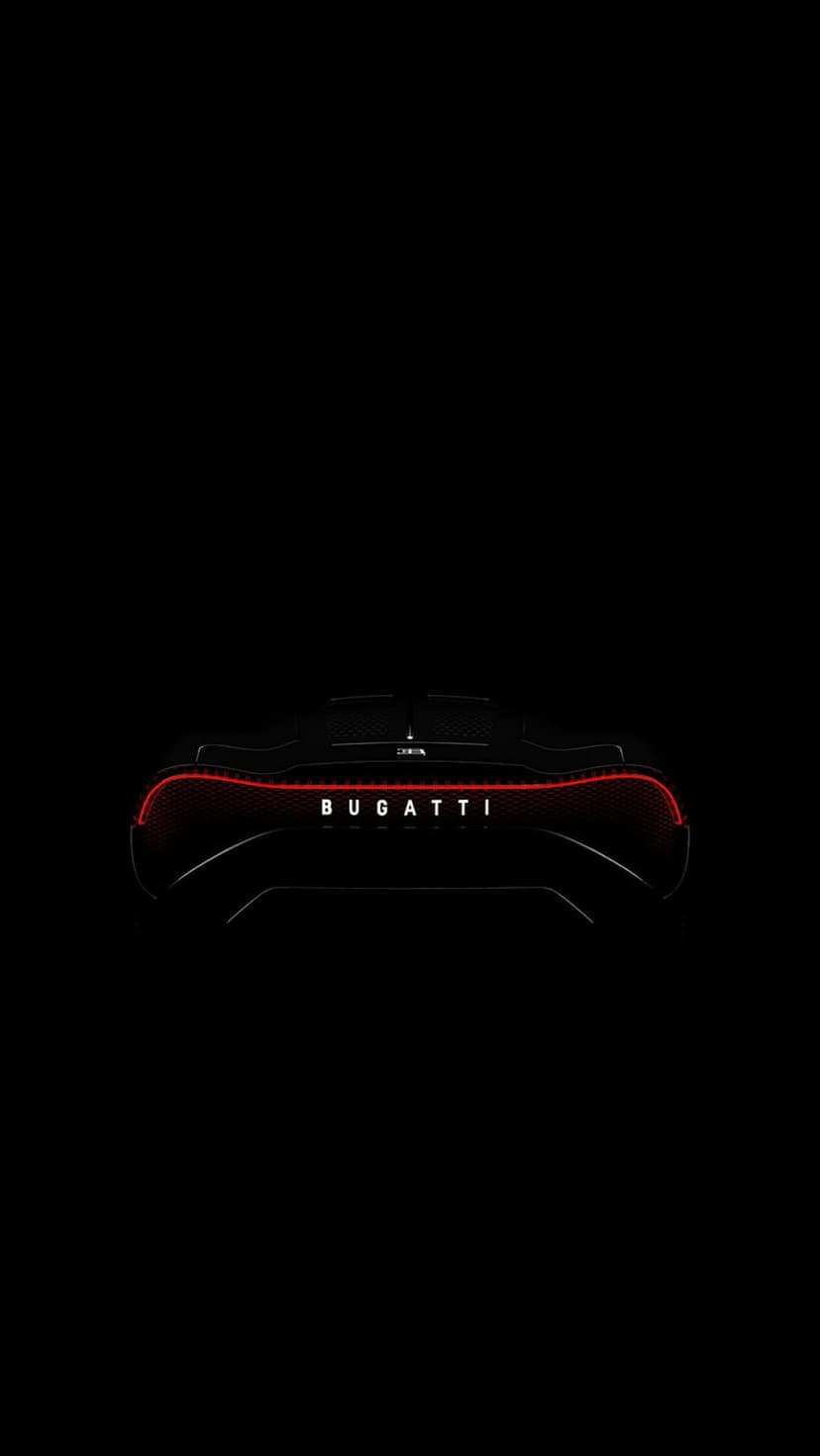 Bugatti rear light strip and white logo centered on a black car body in a dark, minimalist composition.