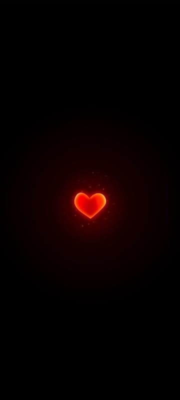 Glowing Red Heart on Black Background with Particles