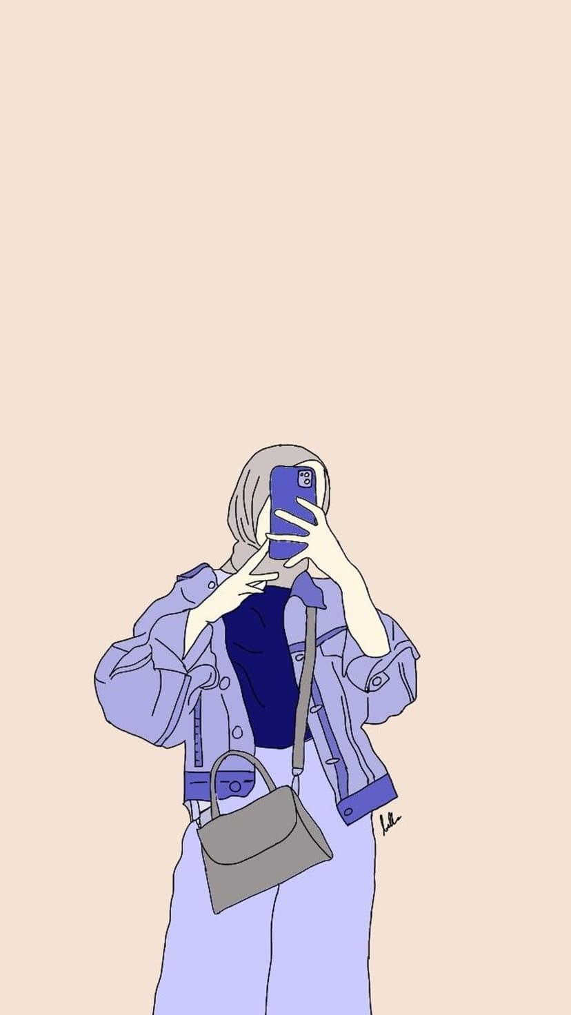 Woman in a hijab and denim jacket holds a phone and handbag while taking a selfie against a plain background.