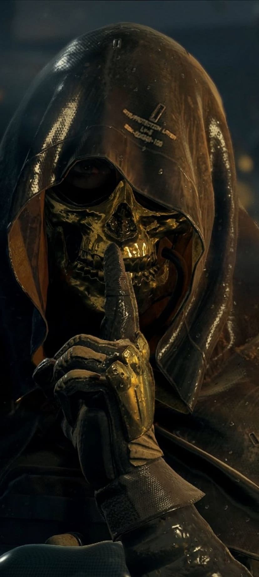 Golden skull masked figure in a dark wet hood holds a gloved finger to their lips in a silence gesture.