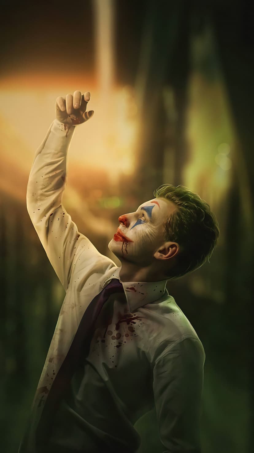 Arthur Fleck with smeared clown makeup and blood on a white shirt reaches toward a bright light in a dark room.