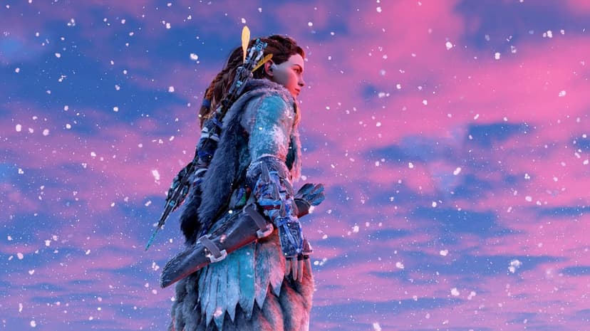 Aloy from Horizon Zero Dawn in winter gear stands amidst falling snow against a pink and blue sunset sky.