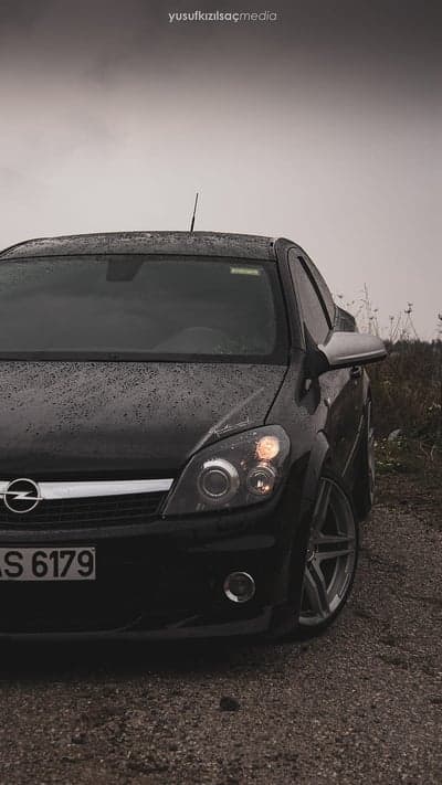 Dark Opel Astra Coupe in Rain with Textured Ground