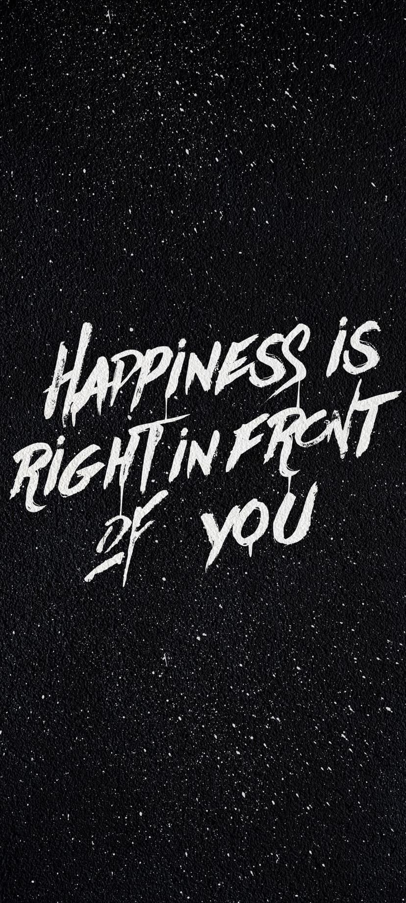 White hand-drawn quote text saying happiness is right in front of you on a black starry textured background.