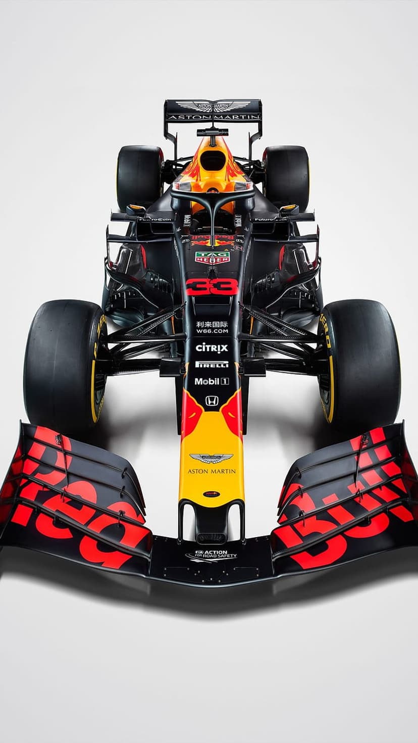 Red Bull Racing F1 car nose and front wing with navy blue livery, yellow accents, and Pirelli tires on a track.