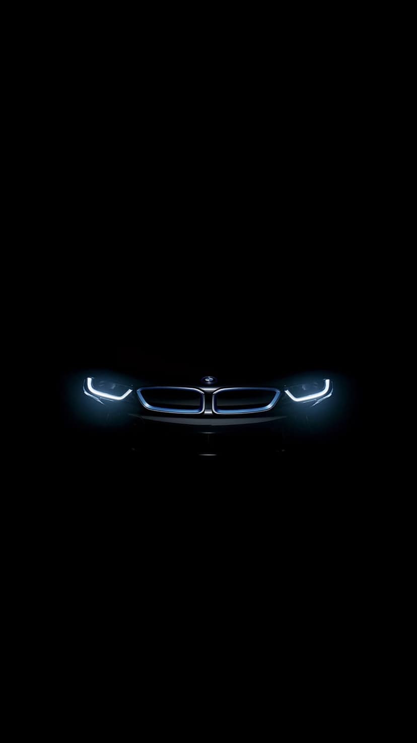BMW i3 LED headlights and kidney grille glowing brightly against a solid black background in a minimalist style.